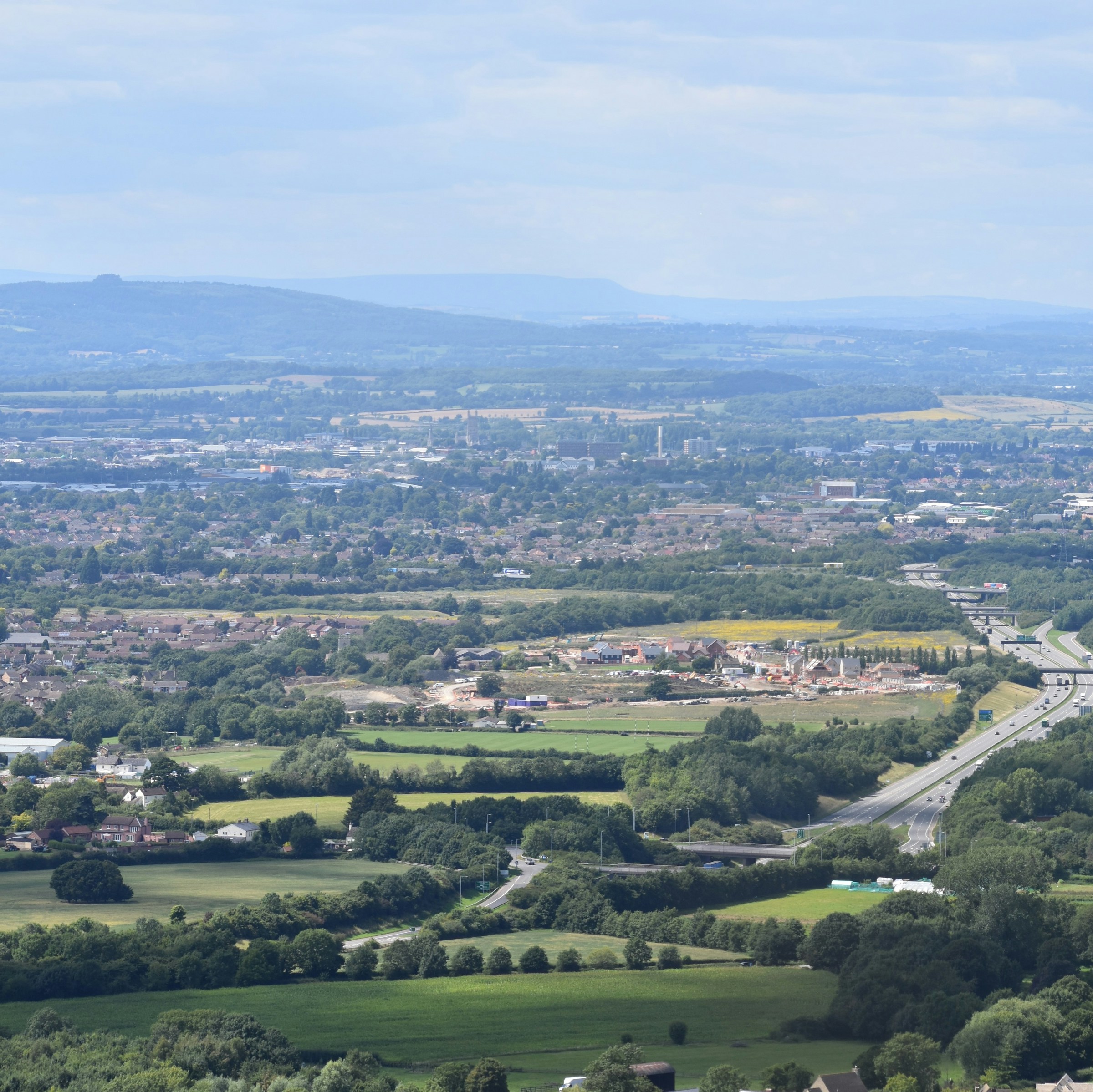 Aerial view of a Cotswold green field looking towards the horizon.